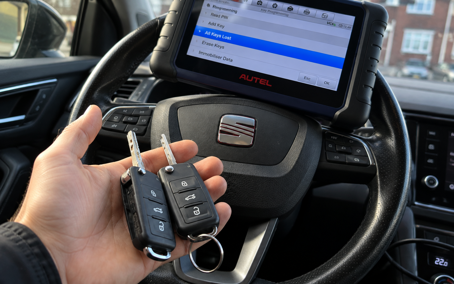 Mobile automotive locksmith working on a car key